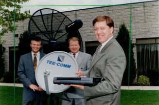 Some dish: Tee-Comm vice-presidents Ted Boyle, front, and Murray Klippenstein, left back, and president Al Bahnman display smaller, cheaper TV dish.