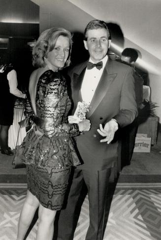 Wearing a black lace sequinted dress with back interest is Barbara Soule, a leasing manager with BCE Development Corp. With her is Erick Baillie, vice-president, Kert Advertising.