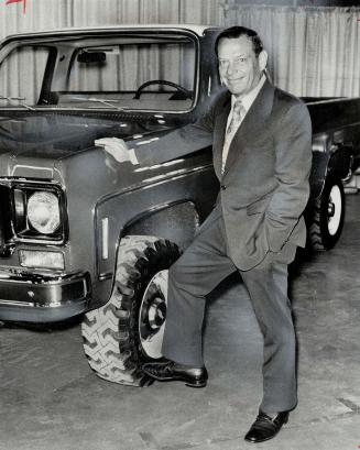 Time-Honored test of kicking the tires is administered by GM Canada's John D. Baker. The pickup truck-a 4-whell-drive Cheyenne Super 20-stood up well to presidential punt. 1974-model GM vehicles were on display at Moss Park.