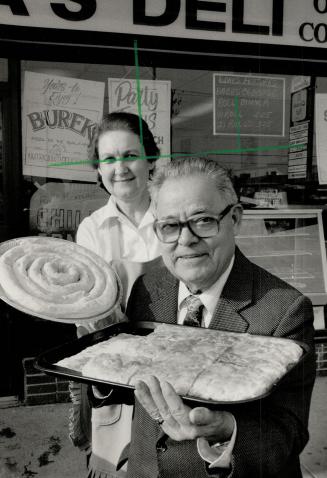 Baba's goodies: Paul and Zorka Bassil proudly display some of the delicacies sold at their deli on Kennedy Rd. The couple have been in the restaurant business for years and retired in 1982, but boredom and a love of work led them to open a deli that specializes in old-country baking.