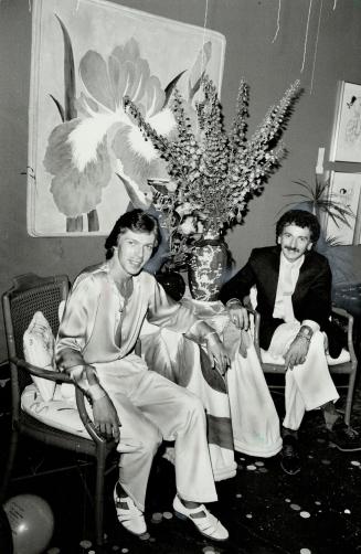 Elegant setting: Toronto party co-ordinator Van Beltrame (right) and artist Jack Thurling make use of green lacquer bamboo armchairs at Van Beltrame's Richmond St. Showroom.