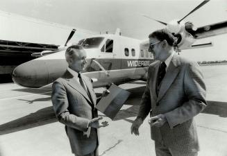 Canada booster: Per Bergsland, left, president of Norway's Wideroes Airlines, takes delivery of another aircraft to add to his all-de Havilland fleet from president John Sandford.
