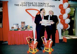 Thomas Bitove (left), and Loblaws' Brian Davidson invite airline passengers to land in new market at Pearson International.
