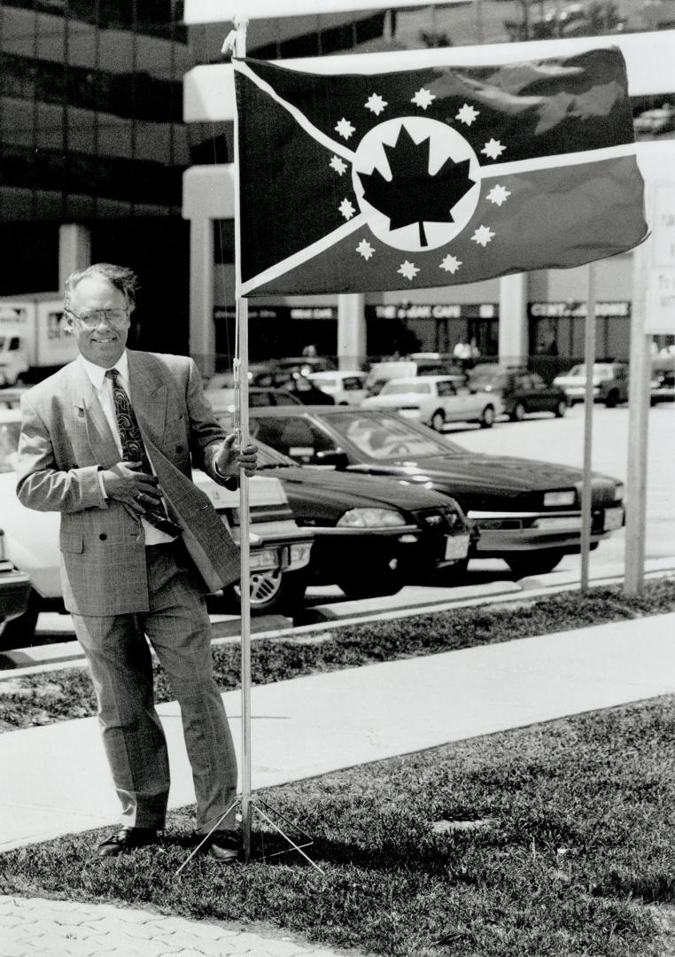Flag that binds: Allan Black of Oshawa has designed a unity flag for Canada. It has 12 compass roses to represent the equality of the provinces and territories. He hopes flags will help people think about their country.