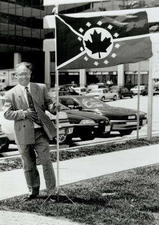 Flag that binds: Allan Black of Oshawa has designed a unity flag for Canada. It has 12 compass roses to represent the equality of the provinces and territories. He hopes flags will help people think about their country.