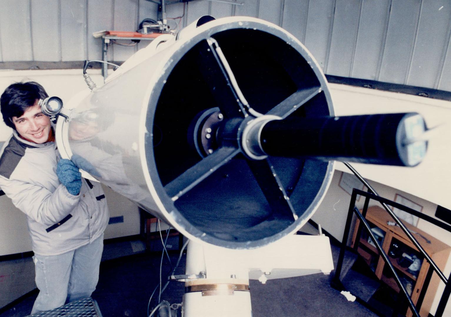 To life!, Diethard Bohme, chairman of York University's chemistry department, peers through a selected ion flow tube, a machined steel piston in which reactions between ions and molecules found in outer space are studied.