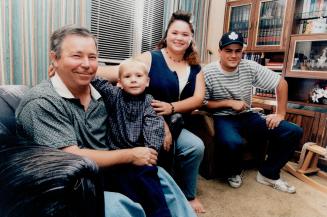 Lucky to be alive: Barry Boniface, with grandson Brandon Jones on his lap, is alive thanks to a stranger's kindness. Looking on are daughter Jennifer and son Jason.
