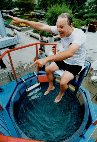 Mike Brown, Metro's deputy chief administrative officer, warns his co-workers not to dunk him as they launch a drive to raise $324,000 for the United Way yesterday. They decided he was all wet.