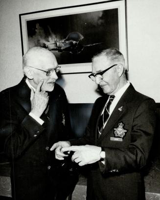 Veterans angered: William Bull, left, president of the Royal Canadian Air Force Association Toronto- York wing, discusses the Billy Bishop movie with Percy Waters, 83, a World War I veteran.