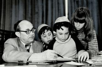 After 40 years: Jack Burke, retiring as principal and teacher of Associated Jewish Schools, has been teaching his own grandchildren there - Michael, 10, David, 8, and Elisa, 12 - as well as the grandchildren of some of his original pupils.