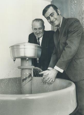 A sprinkling of orders is coming in for group washstation designed by Percy Camp, left, and sold by his son Bryan and a partner. The Thornhill men say the product is competition for a U.S. firm which has cornered the market-making it hard to break in. They blame bureaucracy for slow sales.