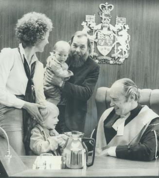 It's like a secular baptism, says County Court Judge Archibald Carter about ceremony when he grants permanent custody of children to adoptive parents. Carter went through his customary warm ceremony for 9-month-old John who became son of Ray and Bambi Reilly. Brother Grant, 4, looks on.