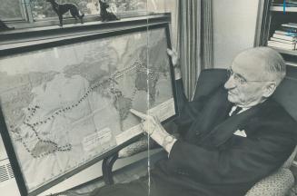 Well-Travelled, 80-year-old Joseph Caulder of Yonge St. holds map showing his travels around the world as a Rotarian. He's pointing to Buenos Aires, one of the many cities in which he spoke to Rotariars. He thinks 1924 convention here greatest.