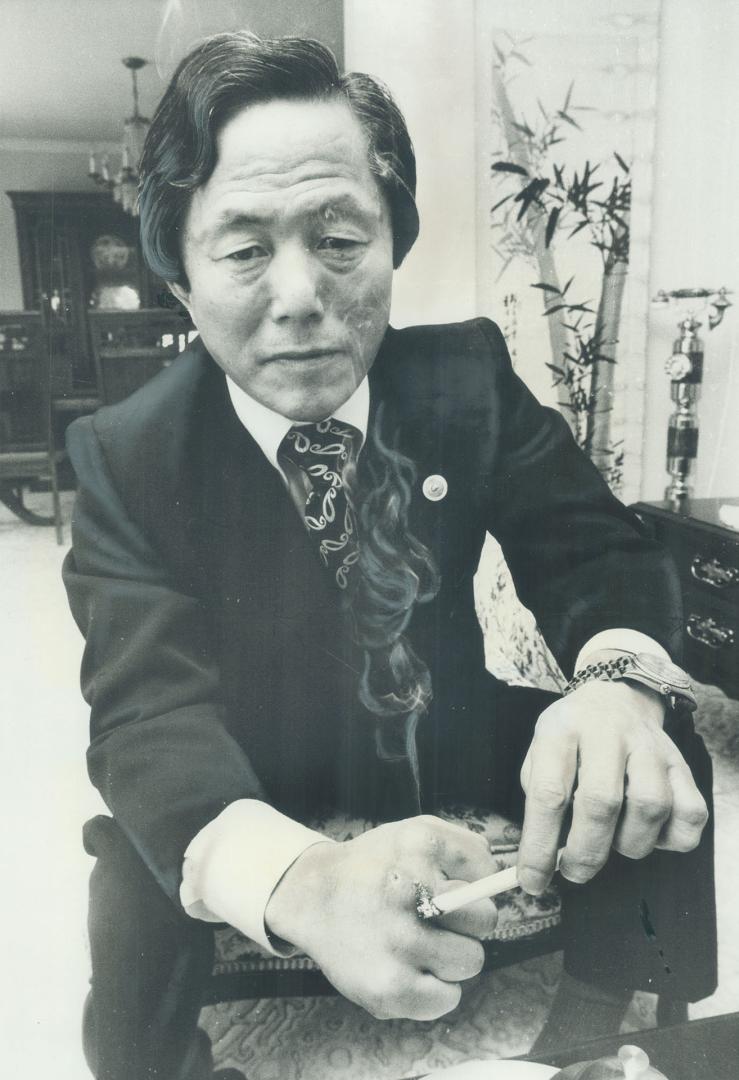 Taekwon-do founder Choi Hong Hi stubs cigarette on his calluses
