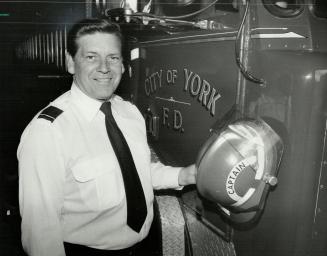 Saying goodbye: Lorne Campbell, a captain with the City of York Fire Department, turns in helmet at the Jane St. fire hall. Campbell, 60, who publishes the national magazine the Canadian Firefighter, was one of Canada's best-know firegighters. He joined York's department in 1947.