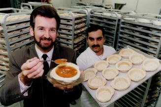 Rising to the occasion: Inventor Mark Chambers tests a fresh batch of edible bread bowls baked by Dino Iaizzo at the Golden Loaf Bakery.