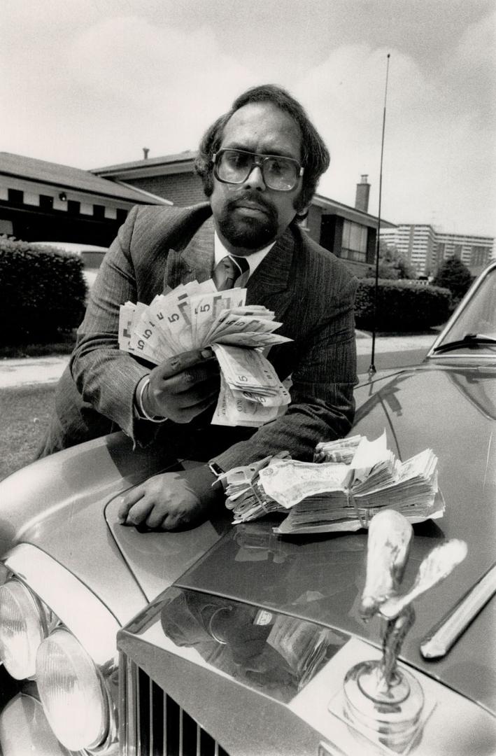 Liberal challenger: Leaning on his Rolls Royce, realtor Sherland Chhangur shows some of the money he collected for new Liberal party memberships in his bid for the York West riding nomination.