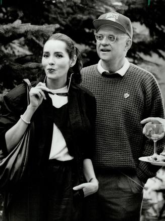 Getting the Canadian angle: Actress Barbara Carrera was escorted by Hollywood's top society columnist, George Christy of the Hollywood Reporter, to director-producer Norman Jewston's outdoor luncheon in Caledon East yesterday afternoon.