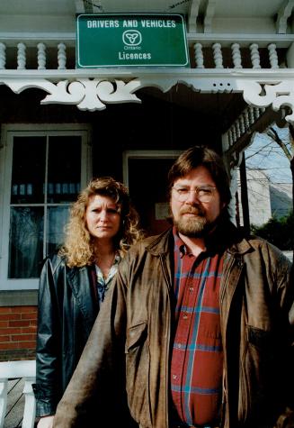 Business threatened: Dave Clark and Darlene Bourdeau stand in front of the Georgetown licensing bureau that's been in his family since 1951.
