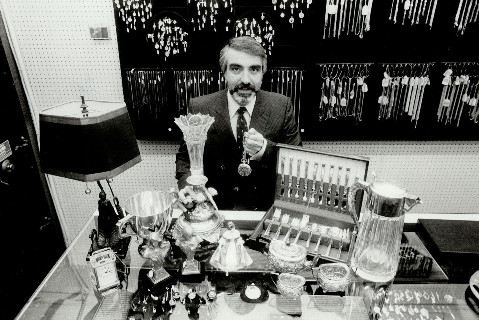 Business booming: Allan Cohen of Grant's Jewellers on Church St. with some of the items that he has bought recently. One man brought in an exquisite emerald he'd paid $34,000 (U.S.) for 2 1/2 years ago. Cohen bought it - for a third of that. I'm looking for a 10 to 15 per cent profit on the stone, Cohen says.