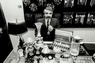 Business booming: Allan Cohen of Grant's Jewellers on Church St. with some of the items that he has bought recently. One man brought in an exquisite emerald he'd paid $34,000 (U.S.) for 2 1/2 years ago. Cohen bought it - for a third of that. I'm looking for a 10 to 15 per cent profit on the stone, Cohen says.