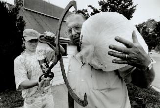The big chill. With his son Glen, 15, ready with tongs, Lionel Core holds one of the bags of ice that will help Metro-area residents through another heat wave. Core's Peel Ice and Fuel Inc. - operated for three generations by his family in Brampton - expects to sell 12 tonnes of ice to the Caribram festival over the weekend.