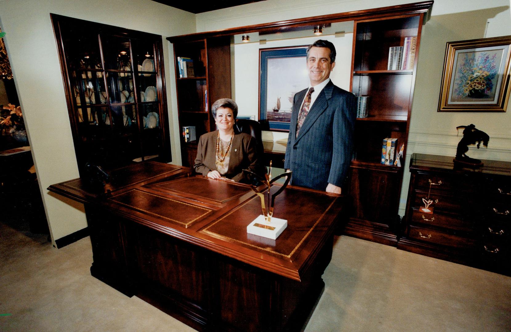 Prize winners: Leda and Lino Confalone of Woodbridge pose with their award winning desk set at the Torotno Furniture Market trade show being held this week in Mississauga.