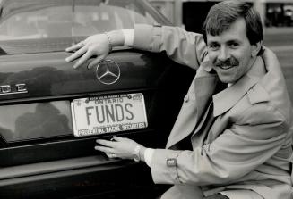 Sign of success: David Cooke of Prudential-Bach Securities shows off the upbeat license plate on his Mercedes-Benz. Now he's considering trading the car for a cheaper model.