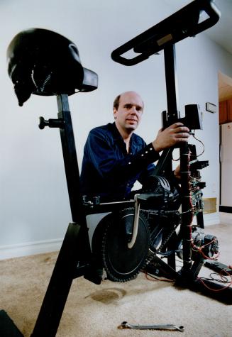 Ted Cooper repairs exercise machines at home, while Colleen Armstrong produces software with her children looking on.