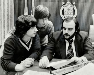 Student representatives Manuel Azevedo (seated) and John Martyniuk (centre) meet with the chairman of the students' rights work group, Trustee Vern Copeland whose job is to mediate among them.