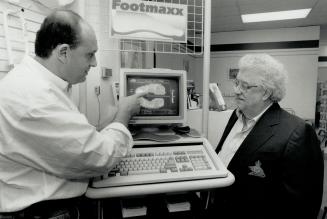 Footmaxx system: Toronto podiatrist Glenn Copeland shows Vaughn Tremblay a computerized Interpretation of the stresses on his feet while in motion.