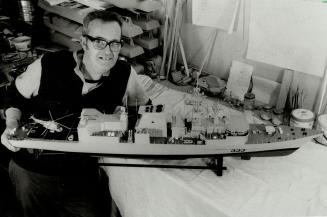 Ready for launch: Master model maker John Craig shows off his latest warship - a scale model of HMCS Toronto. The exnavy man provides scale models of ships for the defence department and will soon have a fleet of 13 ready for delivery. Craig says the real HMCS Toronto will be a 'Humdinger' which will make Canadians proud of their navy again.