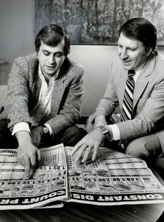 Strategy session: David Cravit, left, of Saffer Cravit and Freedman, goes over some newspaper ads with Doug Stewart, vice-president of marketing for Miracle Food Mart, which fired the first volley in the war.