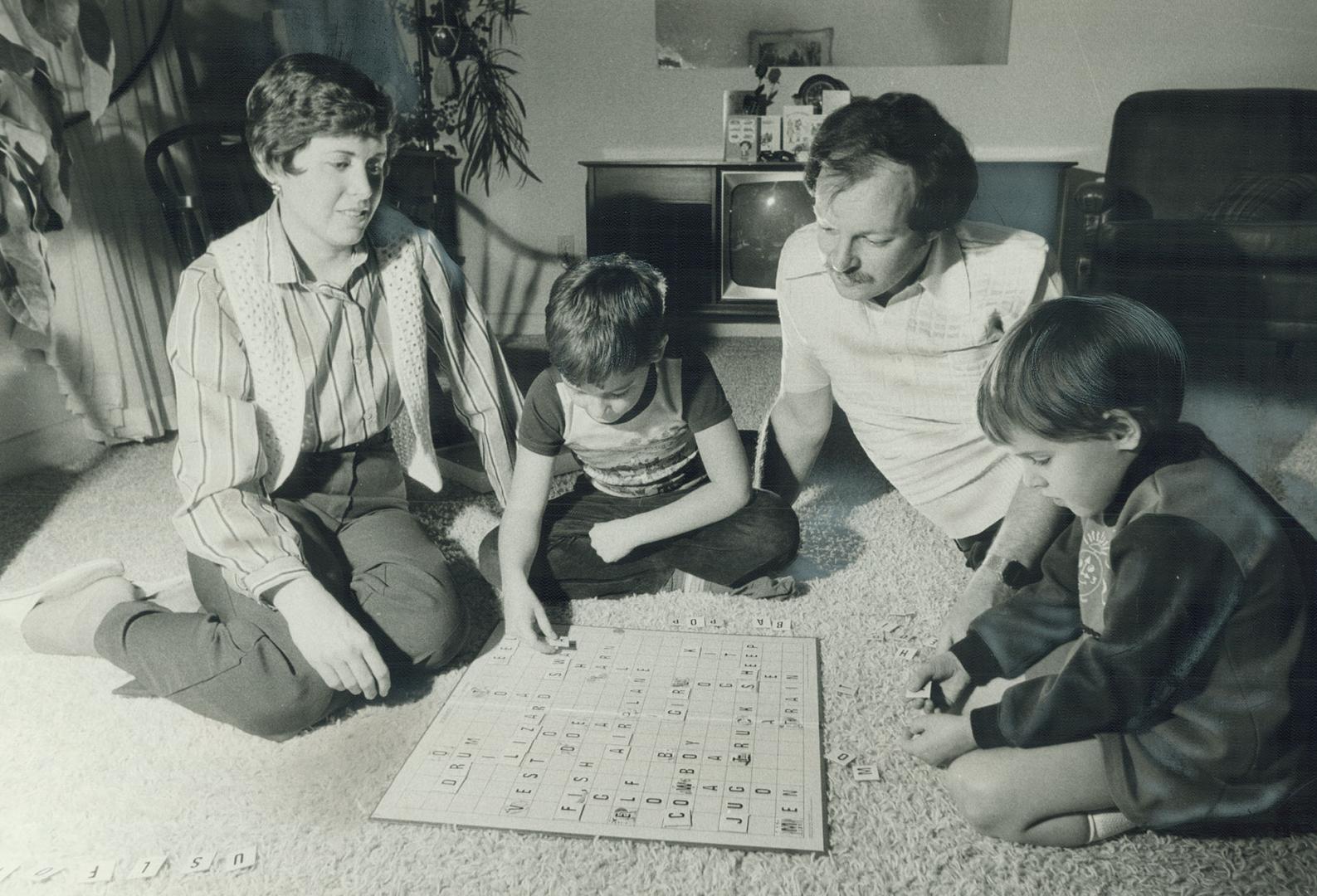 Still learning: Bob and Carol Davies, playing with Bob, 8, and Bronwen, 5, are taking a parent-skills course for the third time