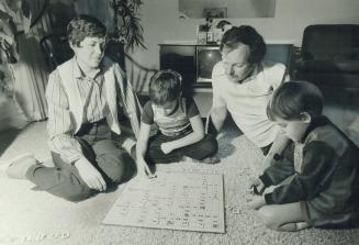 Still learning: Bob and Carol Davies, playing with Bob, 8, and Bronwen, 5, are taking a parent-skills course for the third time