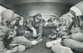 Loading children into the back of his station wagon for a trip home from nursery school, bus operator John Davis says he is breaking the law but he must do it to make a living and I have learned how to carry children in the safest possible way. Police vigilance has been increased since a recent accident that involved a school bus in which 11 child passengers were shaken up.