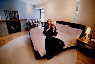 Simple style: Film producer David Daniels relaxes in his undulating -walled media bedroom designed by Phillip Moody. Daniels says it's relaxing and comforting.
