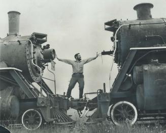 Man in the Middle: Doing the strong man bit between two steam locomotives is Tom Dugelby, railroad buff from Mississauga.