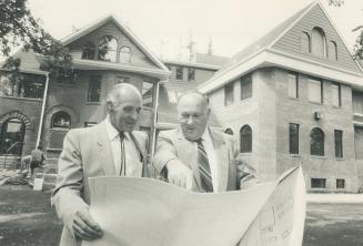Preserving the past: Engineer, Branko Dzeletovic (left) and former area farmer Jim Darlington check the plans for Dzeletovic's renovation of a vintage Maple home behind them.