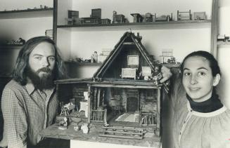 Jack and Beth Eckhardt with one of their dollhouse creations: A log chalet that sells for $250.