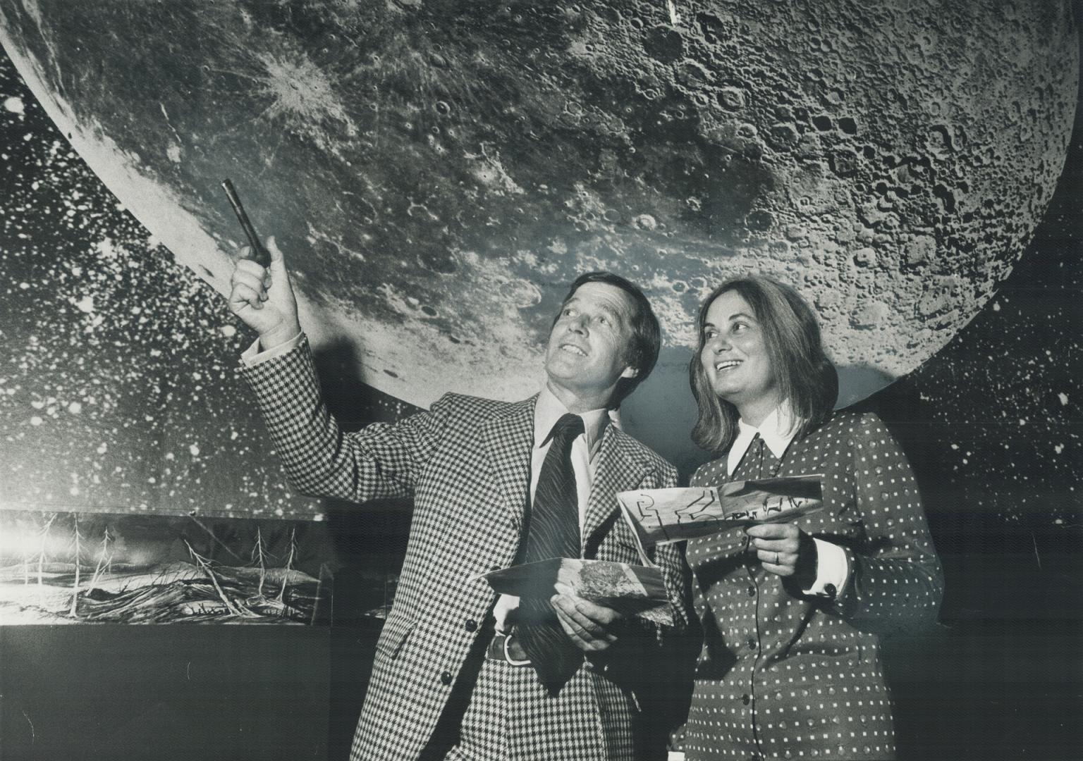 Reaching for the moon: It looks like it as John Eleen, one of the new trustees of the Royal Ontario Museum, points out a display to his wife Luba at the opening of the ROM: Nature's Biographer exhibition last night.