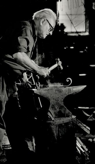 Craftsman at work: Luigi D'Andrea, 67, works on a piece of wrought iron in his workshop in a laneway at Ossington Ave. and Bloor St. D'Andrea, who brought his skills from Italy, has been plying his trade in Toronto since 1949, but now demand for hand-made