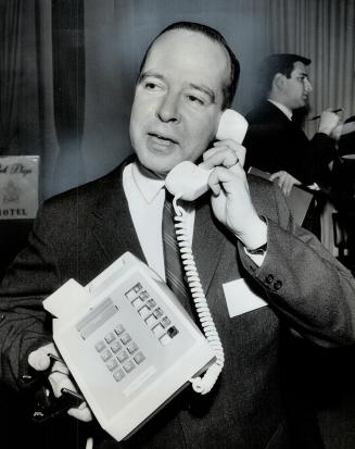 Musical phone plays the market. Touch-tone telephone, demonstrated by Bell vice-president M.N. Davies, can, via a computer link, buy your groceries, place your stock market orders or keep you nicely seperated from your bank manager by doing your banking.