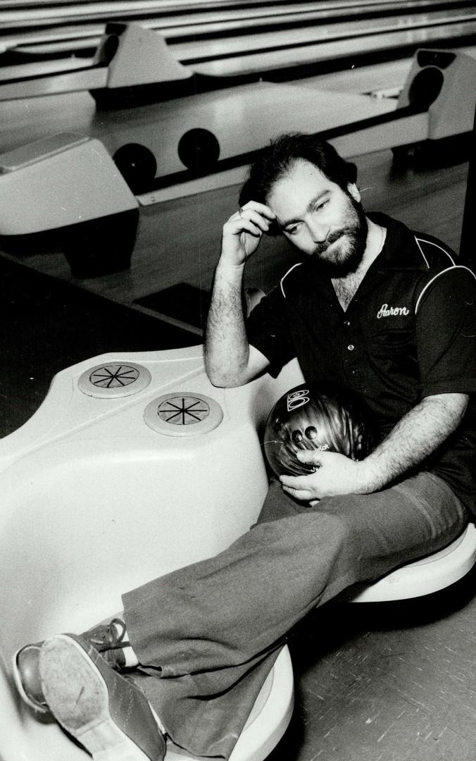 A respite: Aaron Davis puts his feet up before continuing his record performance of bowling non-stop for more than 11 days.