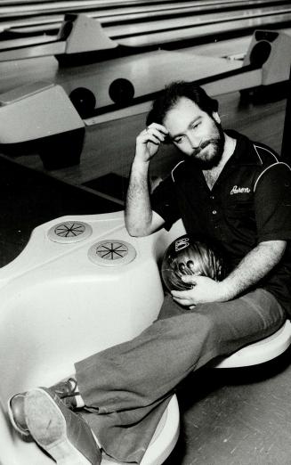 A respite: Aaron Davis puts his feet up before continuing his record performance of bowling non-stop for more than 11 days.