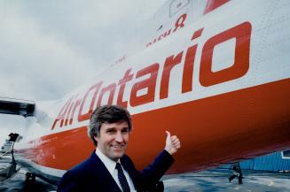 Dash service: Air Ontario president William Deluce displays a Dash 8 on the tarmac at Toronto Island Airport. The airline intends to use the plane for daily trips from the airport to Montreal and Ottawa by April.