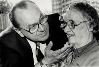 Clear improvement: Gladys Mintz of Toronto is fitted with eyeglasses by Clarence Decaire.