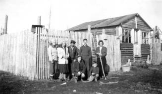Group posing by cabin at Moose Factory