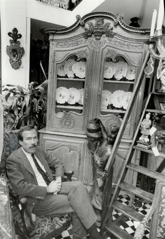 Dramatic jump: Yorkville antique dealer and interior designer Robert Dirstein sits in front of a French pine armoire, circa 1800, he says is worth $11,500 today.