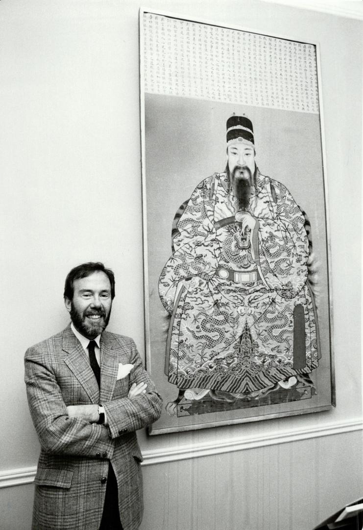 Boldly dramatic: Top Toronto designer Robert Dirstein, right, with his huge embroidered portrait of a mandarin, found about 10 years ago at a Toronto estate auction.